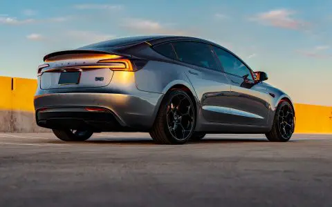 Rear three quarter shot of a Quicksilver Tesla Model 3 Performance parked with UP-05 Forged Wheels.