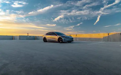 A Quicksilver Tesla Model 3 Performance parked with UP-05 Forged Wheels in a vacant parking lot.