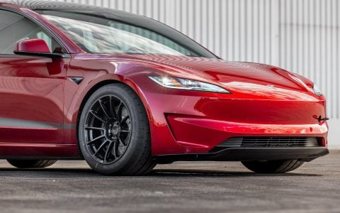 Tesla Model 3 Performance showing rear profile with custom UP-03 Gloss Black Forged Wheels by Unplugged Performance and carbon fiber rear spoiler.