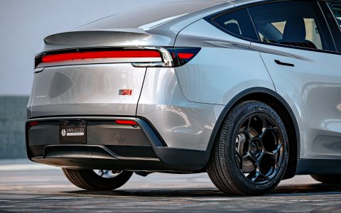 A rear three quarter shot of a 2026 Tesla Model Y Launch Edition with Satin Black 19 inch UP-05 Forged Wheels parked close up.