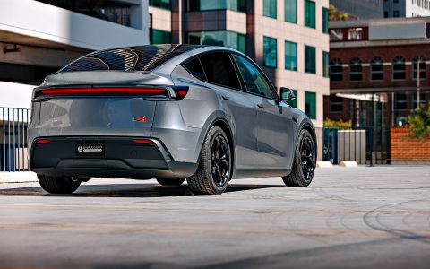 A rear shot of a 2026 Tesla Model Y Launch Edition with Satin Black 19 inch UP-05 Forged Wheels parked in a parking lot.