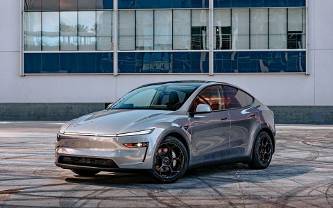 A front three quarter shot of a 2026 Tesla Model Y Launch Edition with Satin Black 19 inch UP-05 Forged Wheels parked in a parking lot.