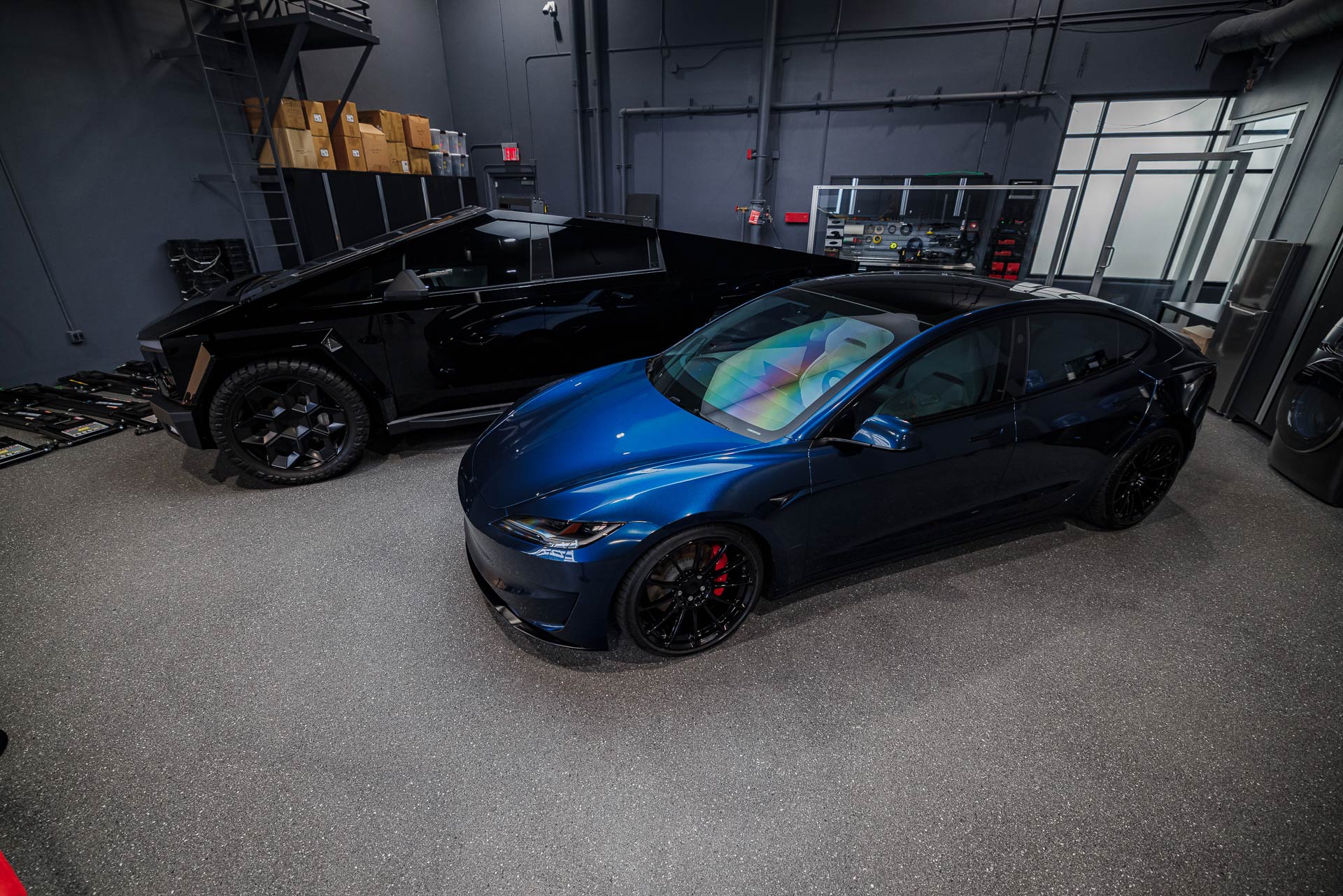 Welcoming Hundreds of Tesla Enthusiasts to Experience the Future of Tesla Customization 14 Gloss Black Wrapped Tesla Cybertruck and Excelsior Blue Tesla Model 3 Performance Highland welcome guests at the First-Ever Open House at UP Headquarters.