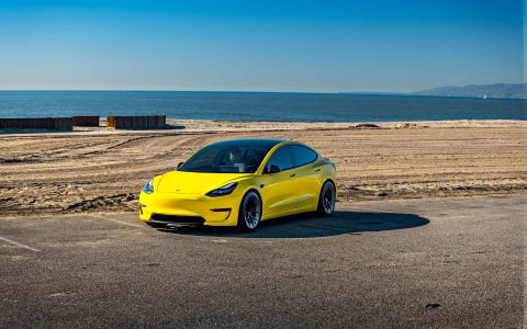 Dark Emerald Metallic Tesla Model 3 Performance Side By Side with Yellow Wrapped Tesla Model 3