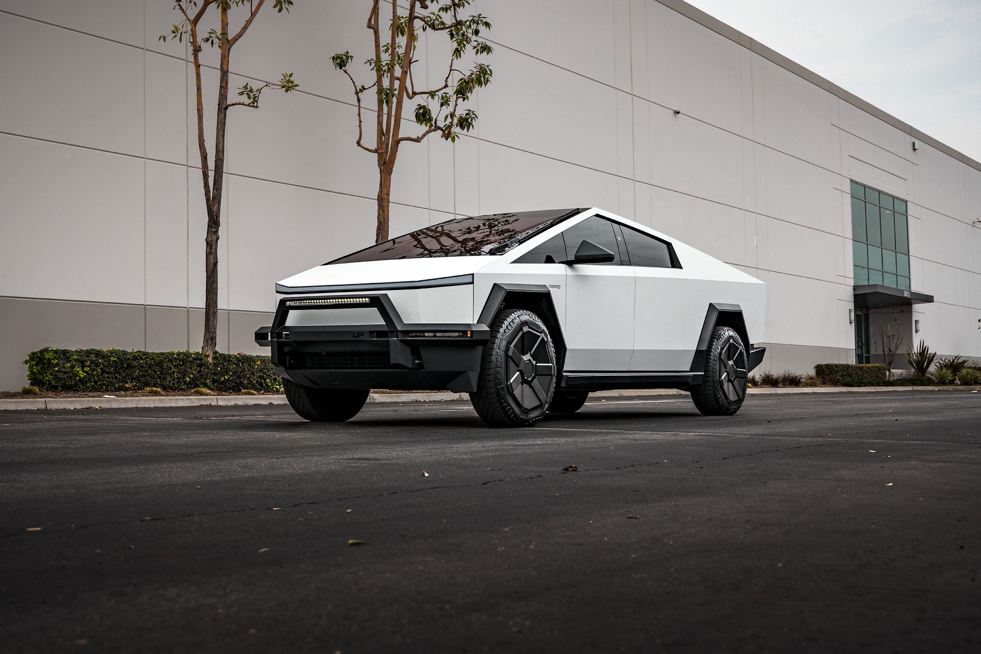White Tesla Cybertruck with UP INVINCIBLE Steel Front Bull Bar and Rock Sliders